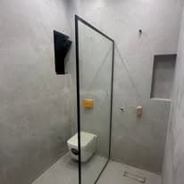 Shower room with a frameless glass screen and large-format wall tiling