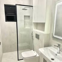 Bathroom with walk-in shower, window, and wall-hung sanitaryware