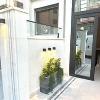 Entrance approach with glass balustrade and planters at a Viola Housing building